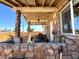 Cozy front porch with stone pillars, seating, and views of the neighborhood at 628 Avenue L, Boulder City, NV 89005