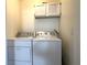 Laundry area featuring a side-by-side washer and dryer with overhead storage at 628 Avenue L, Boulder City, NV 89005