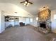 Spacious living room with a vaulted ceiling and stone fireplace at 628 Avenue L, Boulder City, NV 89005