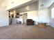 Bright living room with a decorative shelving unit, large windows, and seating at 628 Avenue L, Boulder City, NV 89005