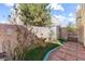 The backyard features a stone patio and lush landscaping at 6317 Beige Bluff St # 3, North Las Vegas, NV 89081