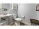 Light and airy powder room features a pedestal sink and modern fixtures at 6317 Beige Bluff St # 3, North Las Vegas, NV 89081