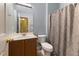 Bright bathroom with a wood vanity, shower/tub combo and tiled flooring at 6317 Beige Bluff St # 3, North Las Vegas, NV 89081