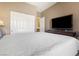 Comfortable bedroom featuring ample closet space and a large-screen television on a wooden dresser at 6317 Beige Bluff St # 3, North Las Vegas, NV 89081