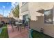 Cozy outdoor patio area with table, chairs, and umbrella for relaxed outdoor living at 6317 Beige Bluff St # 3, North Las Vegas, NV 89081