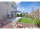 Backyard with artificial grass, rock landscaping, a grill, outdoor seating, and a pergola-covered patio at 6329 Aloha Sue St, North Las Vegas, NV 89031