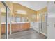 Bathroom with a dual sink vanity, soaking tub, and a glass-enclosed shower at 6329 Aloha Sue St, North Las Vegas, NV 89031