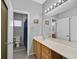 Bathroom featuring a large mirror, sink, and toilet at 6329 Aloha Sue St, North Las Vegas, NV 89031