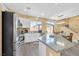 Bright kitchen with white cabinets, granite countertops, stainless steel appliances, and a view to the backyard at 6329 Aloha Sue St, North Las Vegas, NV 89031