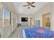 Bright main bedroom with a ceiling fan and a view from large windows at 6329 Aloha Sue St, North Las Vegas, NV 89031