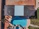 Overhead view of a stylish backyard featuring a pool, spa, and covered patio at 6689 Sparks Ave, Las Vegas, NV 89142