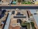 Home featuring solar panels, covered patio, manicured lawn and backyard, viewed from above at 6689 Sparks Ave, Las Vegas, NV 89142