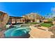 Backyard featuring a pool, hot tub, covered patio, and lush artificial grass at 6689 Sparks Ave, Las Vegas, NV 89142