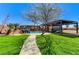 Backyard oasis with a pool, turf, covered patio, and mature trees at 6689 Sparks Ave, Las Vegas, NV 89142