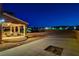 Covered patio with seating overlooks large gravel area, perfect for outdoor activities and entertaining in the evening at 6689 Sparks Ave, Las Vegas, NV 89142