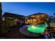 Gorgeous backyard pool with a covered patio, enhanced by a stunning rock waterfall feature at 6689 Sparks Ave, Las Vegas, NV 89142