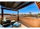 Relaxing balcony with comfortable seating, a covered pergola, and views of the community pool at 6689 Sparks Ave, Las Vegas, NV 89142