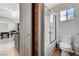 Bathroom features a toilet, a bathtub, a sliding glass door, and tile flooring at 6689 Sparks Ave, Las Vegas, NV 89142
