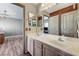 Spacious bathroom with double sinks, large mirror, modern fixtures, and wood accent wall at 6689 Sparks Ave, Las Vegas, NV 89142