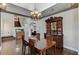 Dining room with chandelier, wood floors, and views to the staircase at 6689 Sparks Ave, Las Vegas, NV 89142