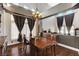 Traditional dining room featuring a chandelier and decorative curtains at 6689 Sparks Ave, Las Vegas, NV 89142