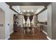 Chandelier lit dining room with dark wood floors and gray accent walls at 6689 Sparks Ave, Las Vegas, NV 89142