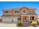 Charming two-story home featuring a three-car garage, well-maintained landscaping, and an inviting front porch at 6689 Sparks Ave, Las Vegas, NV 89142