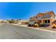 Attractive two-story house with a three-car garage, desert landscaping, and a street view at 6689 Sparks Ave, Las Vegas, NV 89142