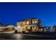 Beautiful two-story home at dusk with a manicured lawn, three-car garage, and welcoming front porch at 6689 Sparks Ave, Las Vegas, NV 89142