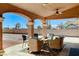 Covered patio with seating, beautiful support beams and spacious backyard at 6689 Sparks Ave, Las Vegas, NV 89142