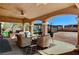 Inviting covered patio with wicker furniture overlooking a pool and backyard at 6689 Sparks Ave, Las Vegas, NV 89142
