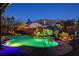 Beautifully landscaped pool with rock waterfall feature, set against a backdrop of scenic mountains at 6689 Sparks Ave, Las Vegas, NV 89142
