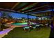 Backyard featuring a custom pool and spa with overhead structure and lighting, ideal for outdoor entertaining at 6689 Sparks Ave, Las Vegas, NV 89142