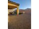 Gravel backyard featuring a covered patio with outdoor seating and artificial turf at 697 Sunray Park St, Henderson, NV 89011