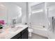 Clean bathroom with white tile, a modern vanity, and a combined tub and shower at 697 Sunray Park St, Henderson, NV 89011