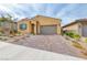 Charming single-story home boasts a brick driveway and well-maintained landscaping at 697 Sunray Park St, Henderson, NV 89011