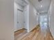 Bright hallway featuring wood-look floors and modern white doors at 697 Sunray Park St, Henderson, NV 89011