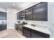 Bright kitchen features stainless steel appliances and eat-in quartz countertop and gray vinyl floors at 697 Sunray Park St, Henderson, NV 89011