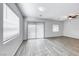 Bright living room features modern gray vinyl floors and large sliding glass doors to maximize natural light at 697 Sunray Park St, Henderson, NV 89011