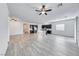 Open-concept living space with kitchen island and wood-look floors at 697 Sunray Park St, Henderson, NV 89011