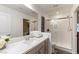 Well-lit bathroom with double vanity, modern fixtures, and a glass-enclosed shower for a spa-like experience at 7153 Grace Estate Ave, Las Vegas, NV 89113