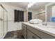 Bathroom featuring a double sink vanity, and shower with dark curtain at 7153 Grace Estate Ave, Las Vegas, NV 89113