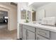 Bright bathroom featuring neutral finishes, a large mirror, and a glimpse into an adjacent bedroom with bunk beds at 7153 Grace Estate Ave, Las Vegas, NV 89113