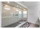 Modern bathroom featuring a spacious glass-enclosed shower and neutral tile at 7153 Grace Estate Ave, Las Vegas, NV 89113