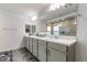 Bathroom showcasing a large mirror, dual sinks, and a spacious shower, perfect for comfort and style at 7153 Grace Estate Ave, Las Vegas, NV 89113