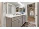 Bathroom featuring a double sink vanity and a doorway to the hallway at 7153 Grace Estate Ave, Las Vegas, NV 89113