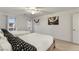 Bright bedroom featuring two beds, white walls, and contemporary artwork creating a serene and stylish space at 7153 Grace Estate Ave, Las Vegas, NV 89113