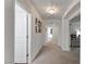 Bright hallway with decorative lighting fixtures provides access to multiple rooms within the home at 7153 Grace Estate Ave, Las Vegas, NV 89113