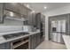 Stylish kitchen with gray cabinets, stainless steel appliances, and modern design elements at 7153 Grace Estate Ave, Las Vegas, NV 89113