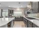 Contemporary kitchen with gray cabinets, a stainless steel sink, and modern appliances at 7153 Grace Estate Ave, Las Vegas, NV 89113